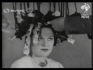 QUIRKY: Newest vogue in hair .Famous hairdresser demonstrates latest fashion. Inspired by ...(1934)